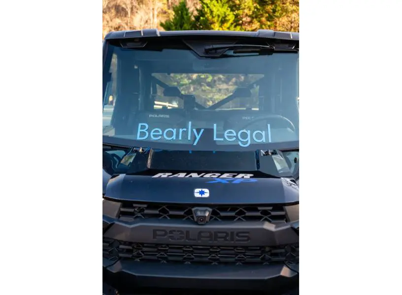 A truck with the words bearly legal written on it.